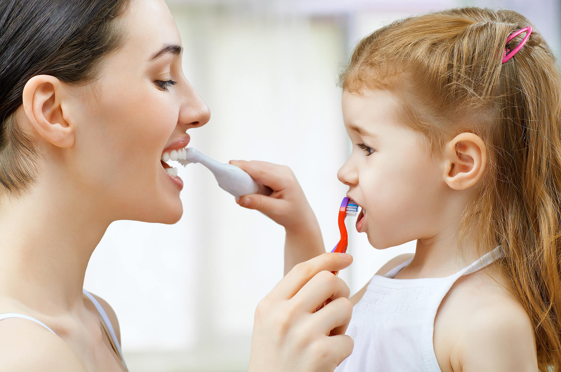 a mother and daughter smiling
